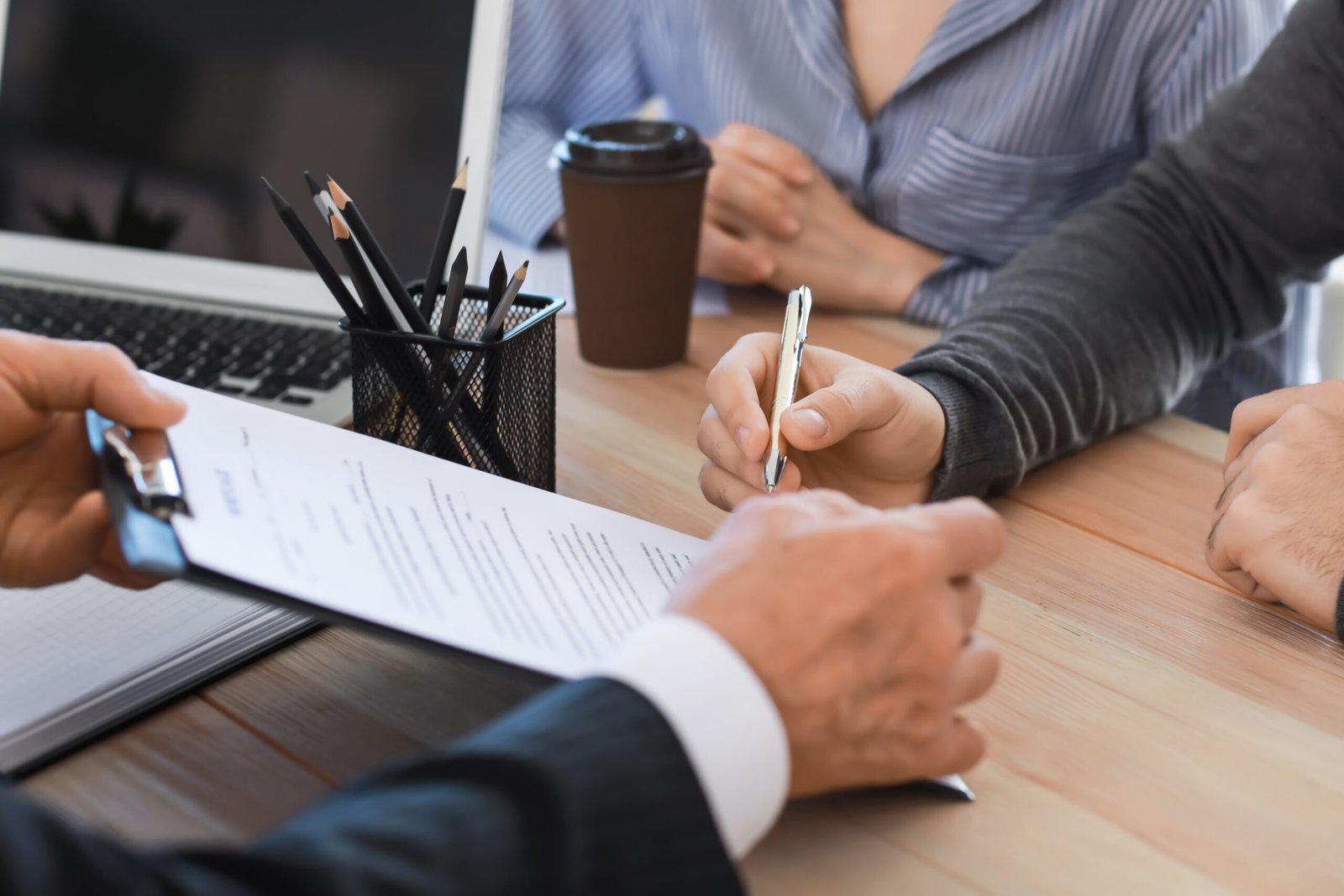 Life Settlement - Couple signing documents at notary public office. SELL A LIFE INSURANCE