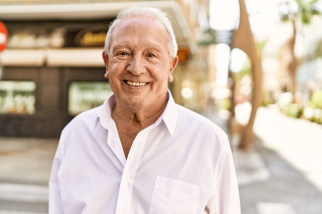 Life Settlement – Senior man with grey hair standing happy outdoors on a sunny day.Senior man with grey hair standing happy outdoors on a sunny day. Smiling happy at 70s for retirement. Life Settlement - Senior man with grey hair standing happy outdoors on a sunny day.