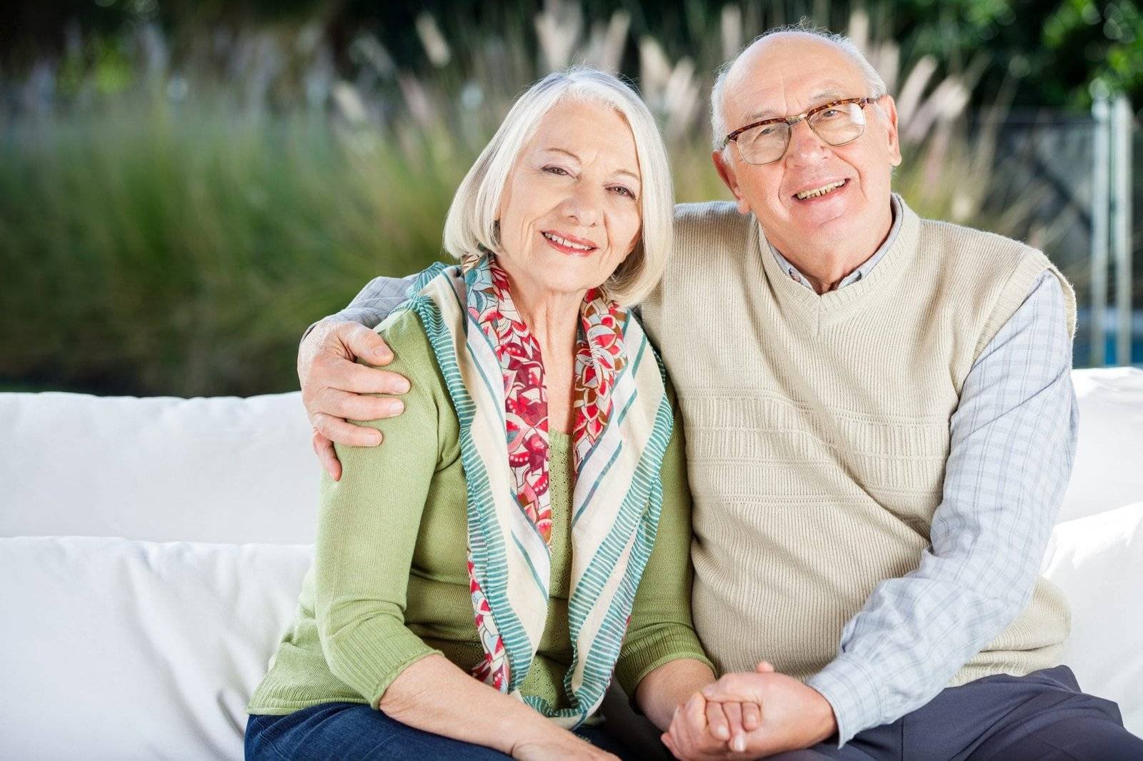 Life Settlement - a senior couple smiling while posing to the camera. USE A VIATICAL SETTLEMENT BROKER