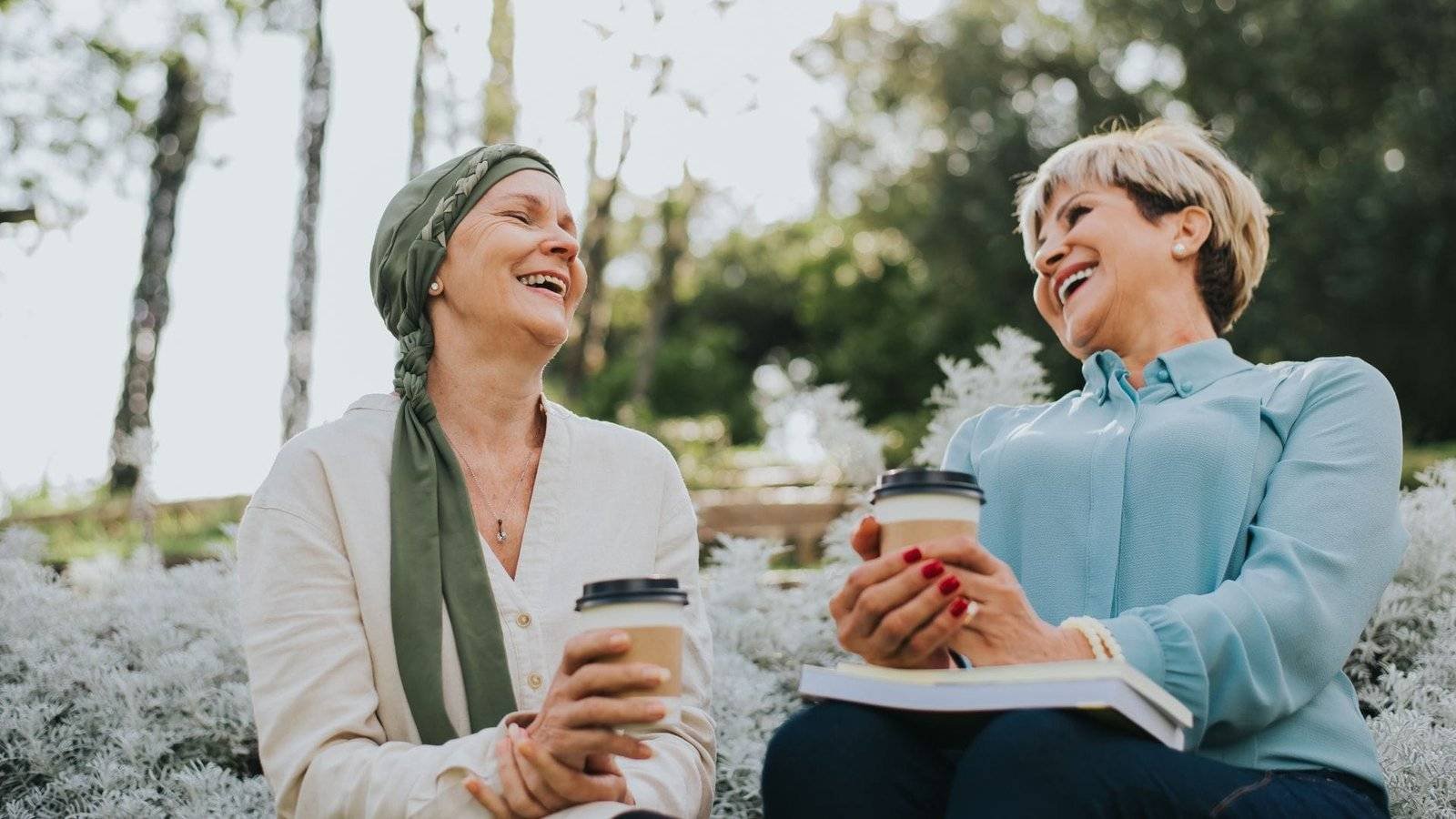 Life Settlements and Viatical Settlements - two women smiling while drinking coffee. Viatical Settlement