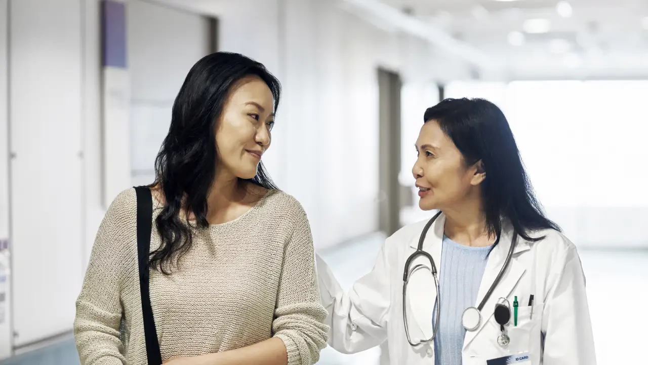 Life and Viatical Settlements - A woman walking with a doctor as the doctor talks. Requirements for Retained Death Benefits