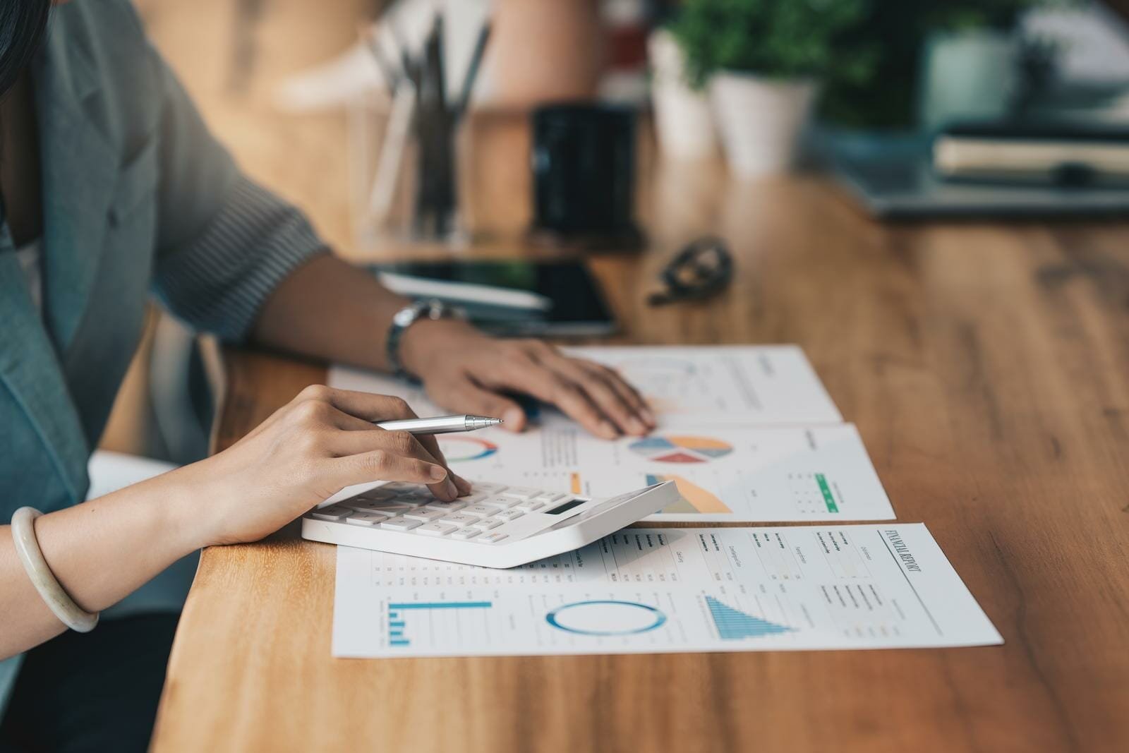 Viatical Settlement Taxes - A woman with a calculator going over papers.