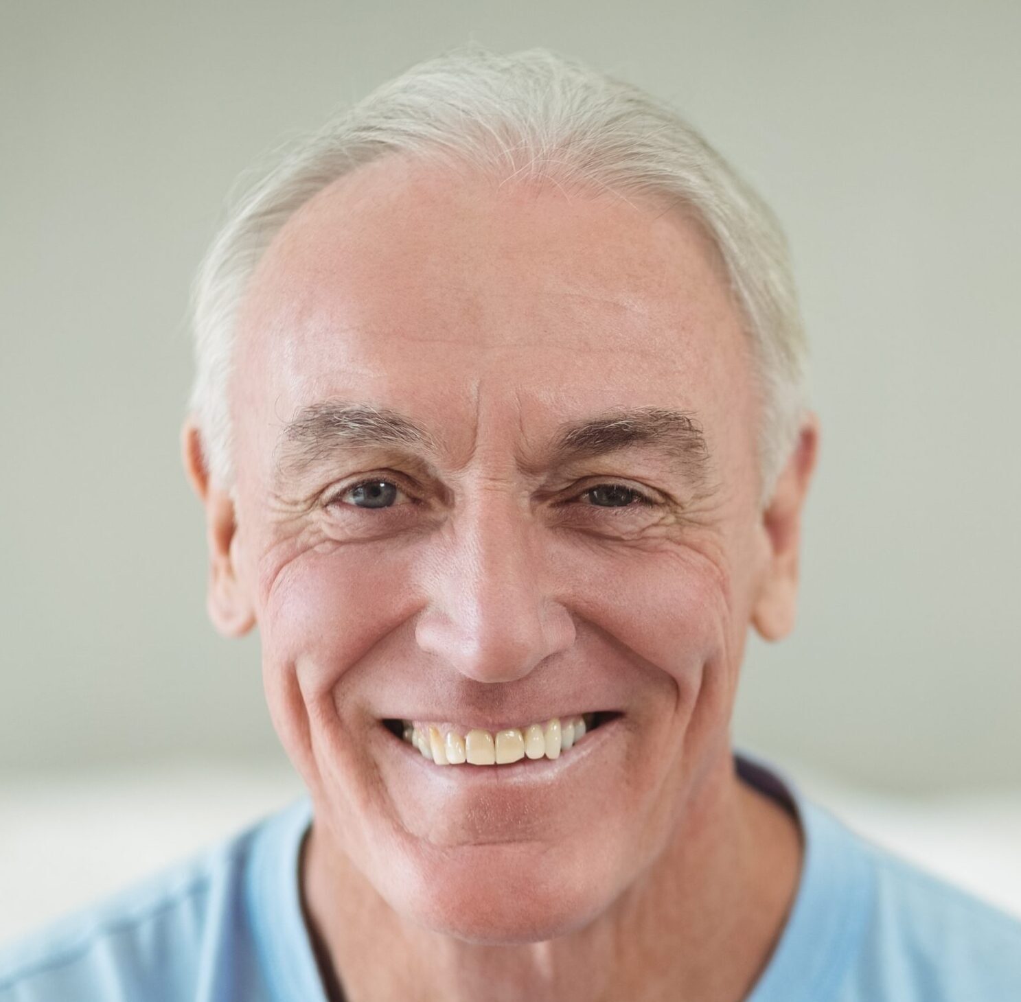 Home 20 Life Insurance -Senior man smiling taking a portrait.