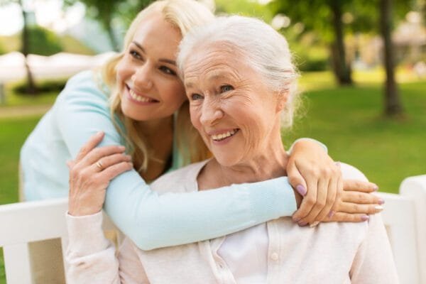 Cash Value and Face Value - A woman hugging her grandmother.