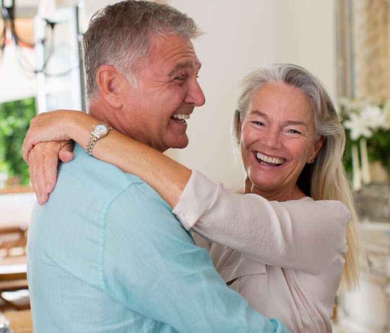 Life Settlement: Happy Senior Couple Embracing with Warm Smiles