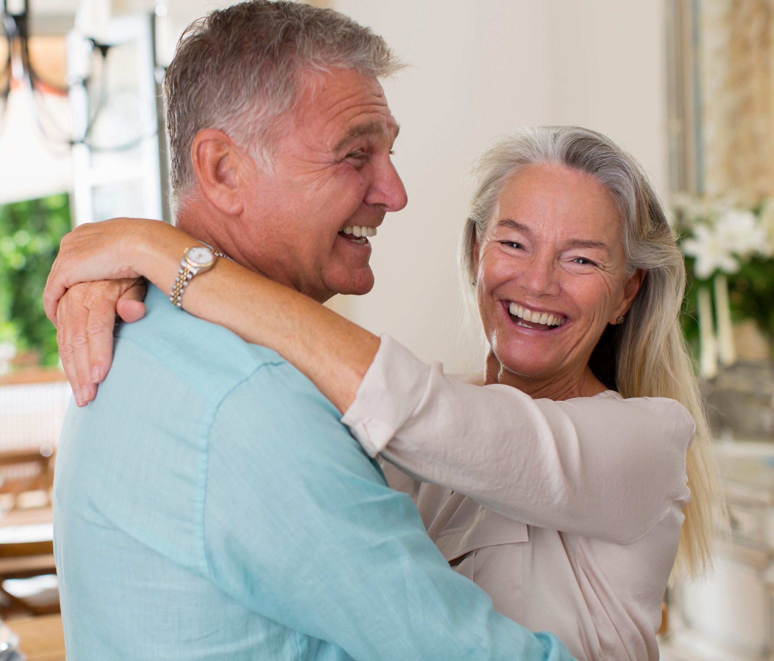 Life Settlement: Happy Senior Couple Embracing with Warm Smiles
