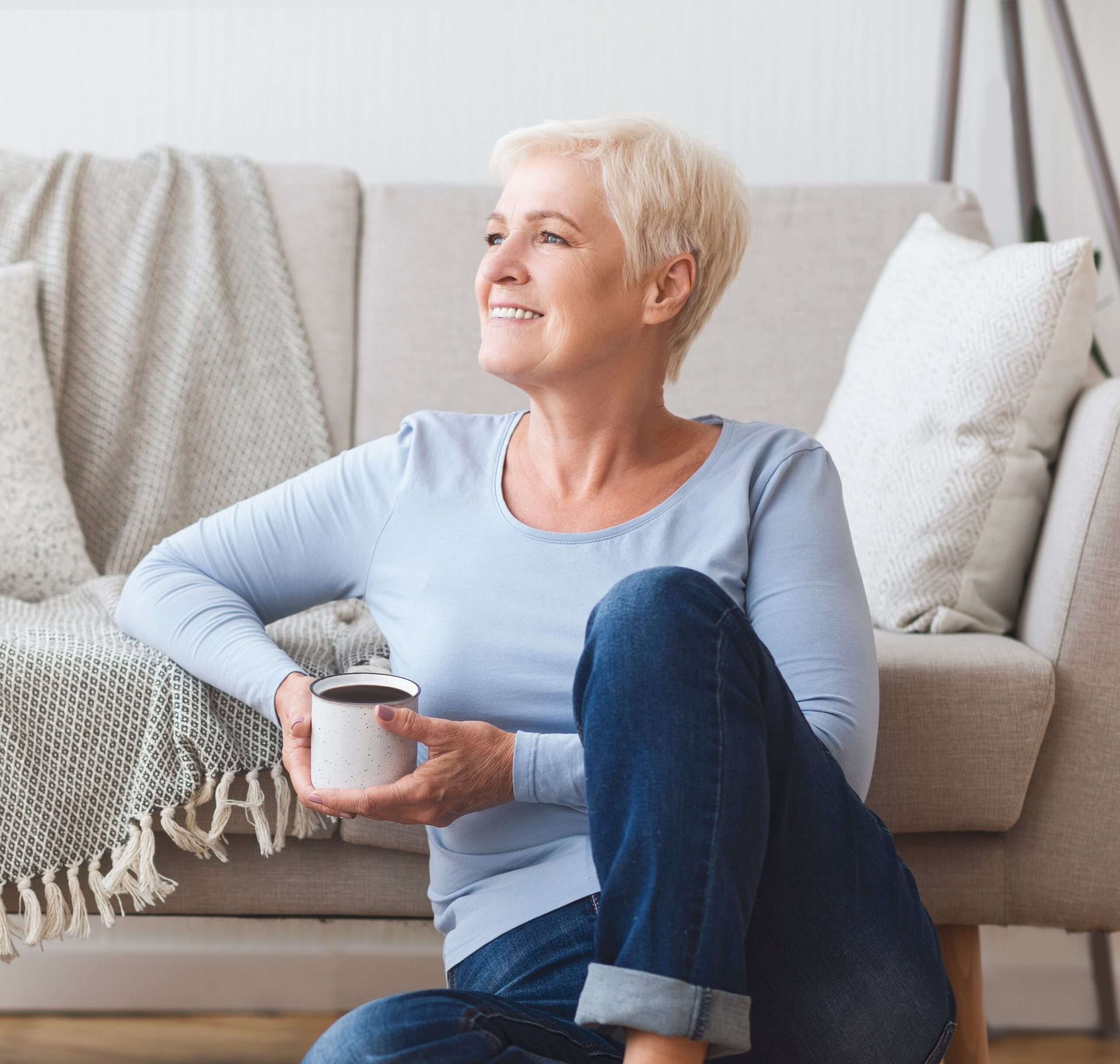 Sell Your Life Insurance Policy- a woman sitting on the floor holding a cup