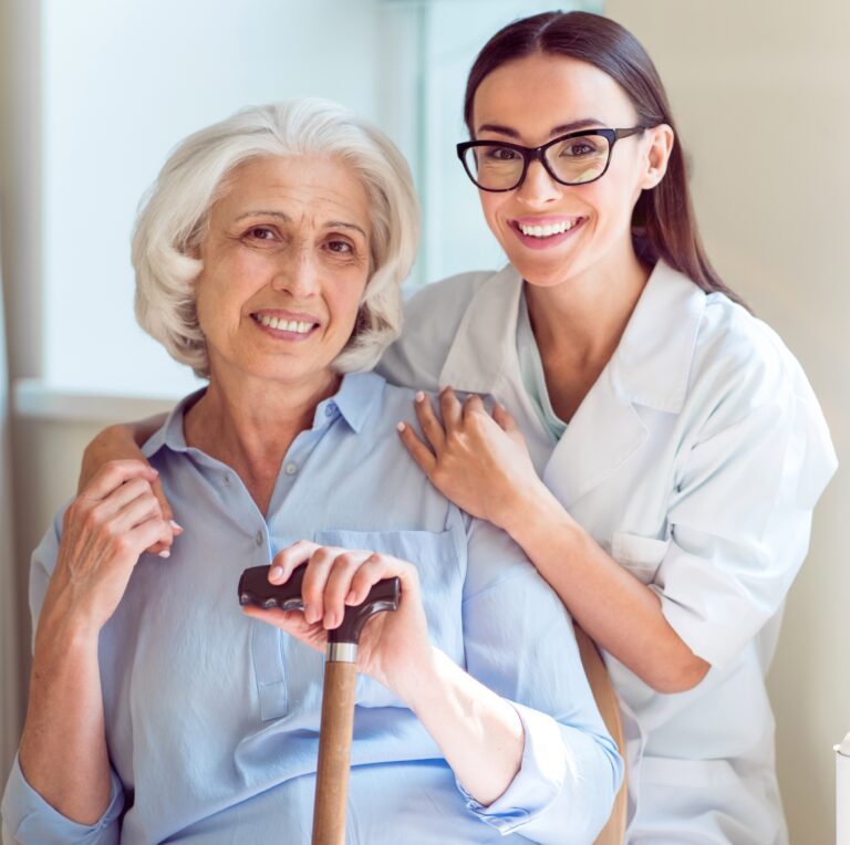 Viatical Settlement Taxes - Senior woman with woman doctor happy and smiling