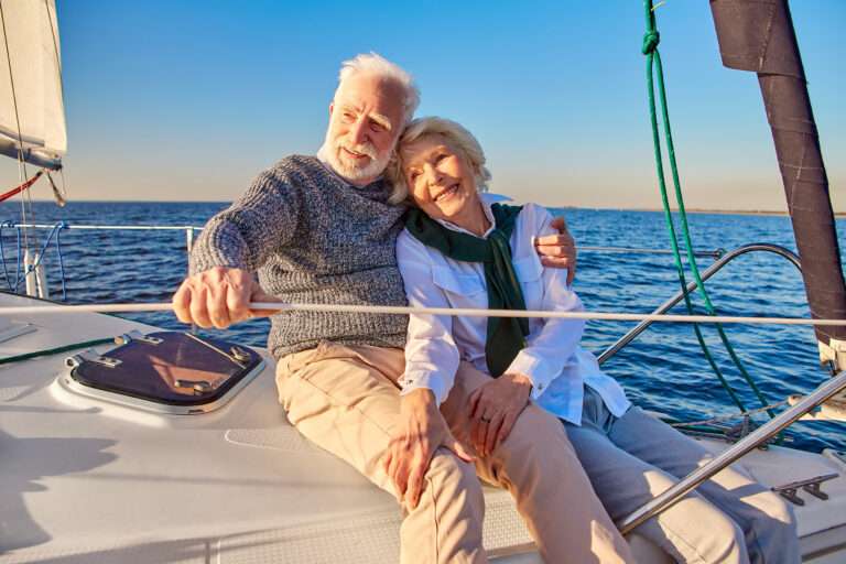 What Is a Life Settlement? - a man and woman sitting on a boat