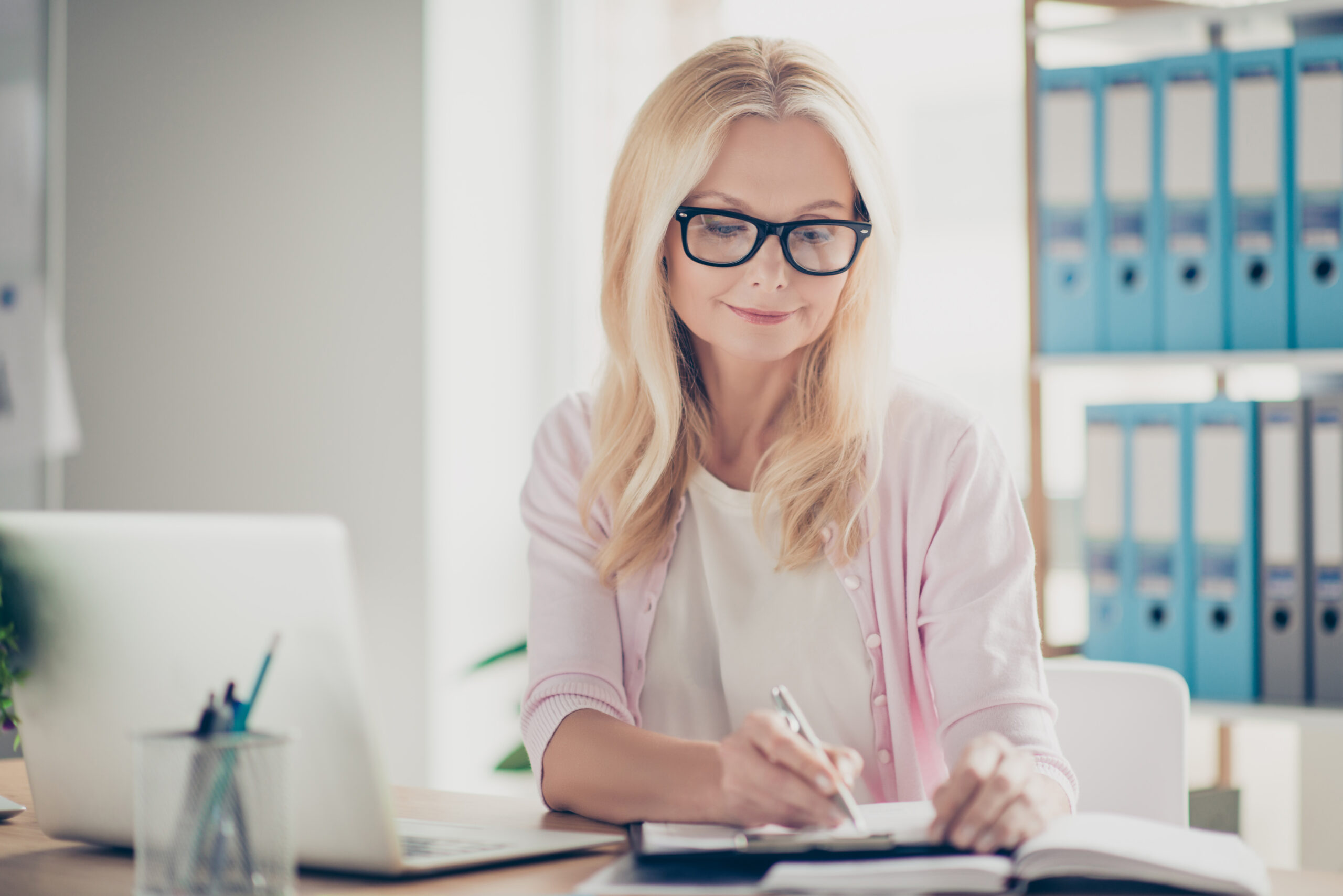 Life Settlement Process - Pretty, nice, cute, confident woman holding pen in hand.