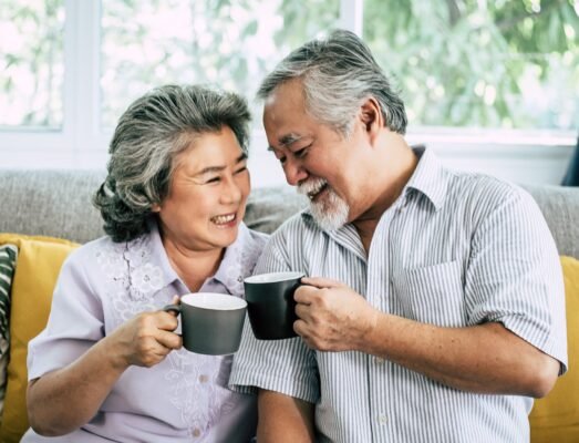 Term Life Insurance: Elderly Smiling couple Talking together and drinking coffee or milk