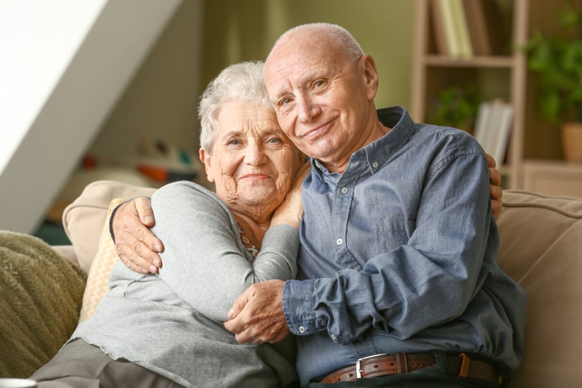 Viatical Settlements - Portrait of happy senior couple at home