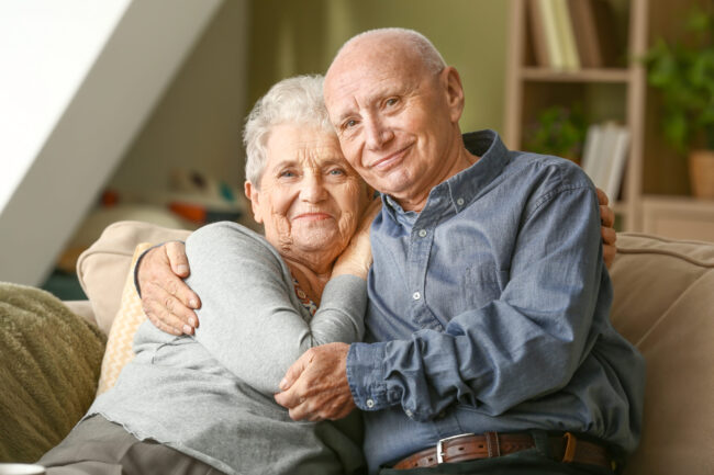 Viatical Settlements – Portrait of happy senior couple at home Viatical Settlements - Portrait of happy senior couple at home