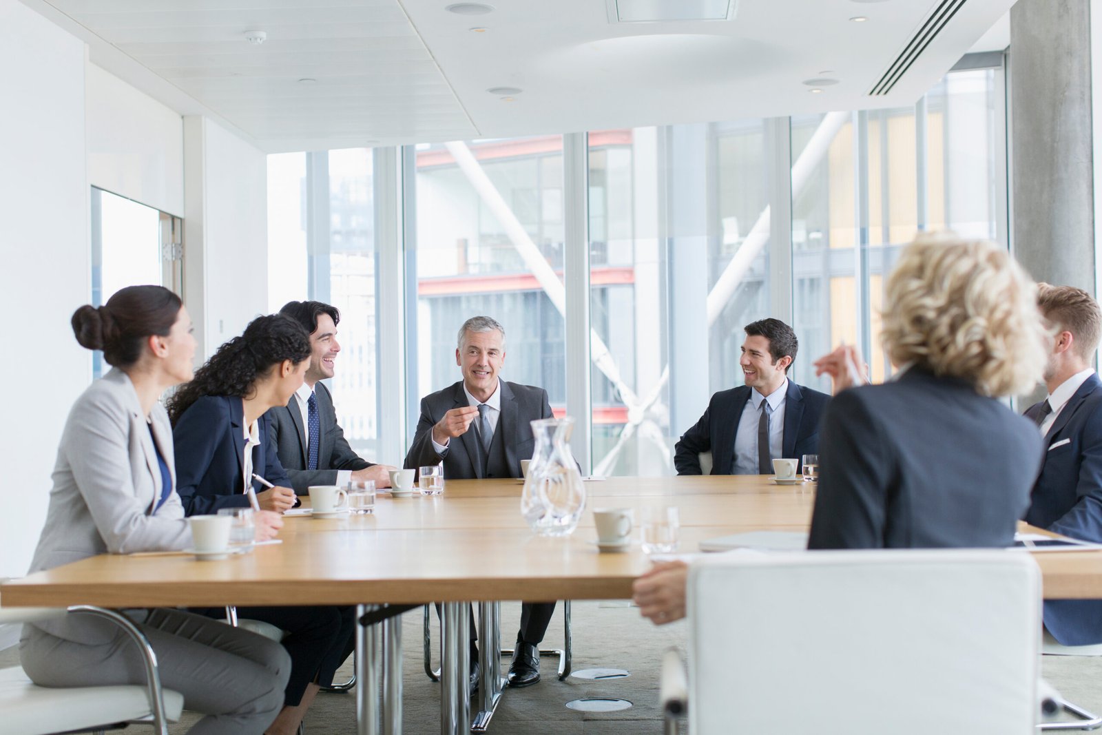 who buys life insurance policies - Corporate business people talking in conference room meeting
