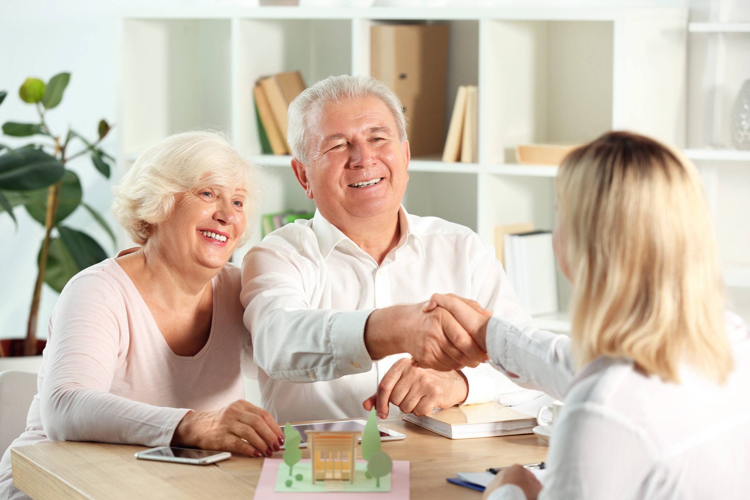 Can I Sell My Life Insurance Policy? Mature man shaking hands with real estate agent in office