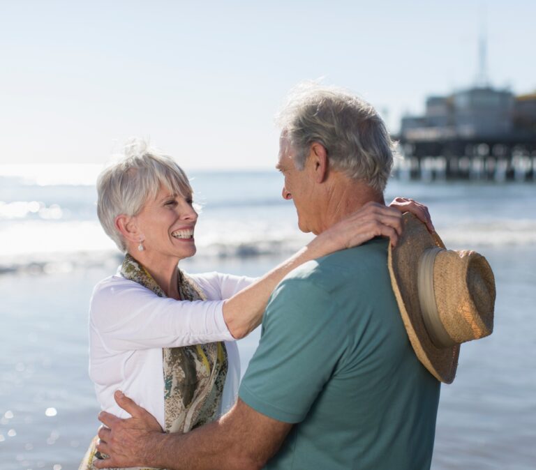 Retained Death Benefit - senior couple on the beach embracing