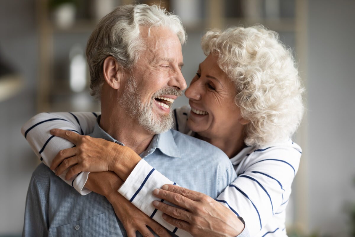 How to Sell Your Life Insurance Policy: Happy elderly couple hug
