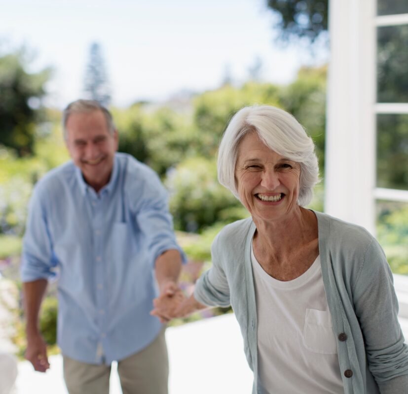 Selling Your life Insurance Policy: Senior couple smiling and holding hands