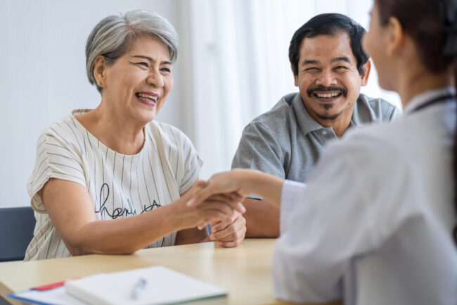 sell term life Insurance policy: happy senior woman with her son talking to an agent sell term life Insurance policy: happy senior woman with her son talking to an agent