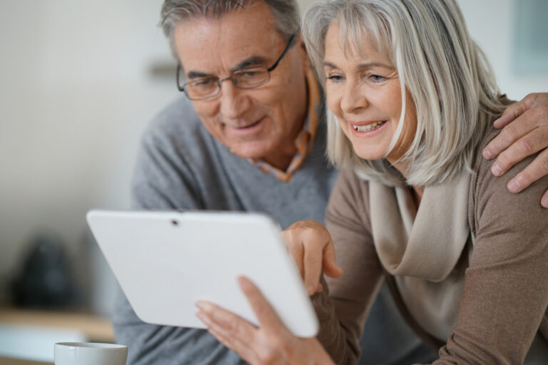Cash Surrender Value: happy senior couple reviewing the life insurance cash out options