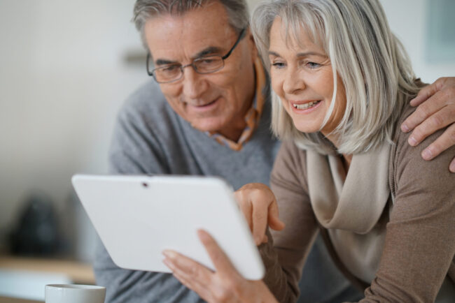 Cash Surrender Value: happy senior couple reviewing the life insurance cash out options Cash Surrender Value: happy senior couple reviewing the life insurance cash out options