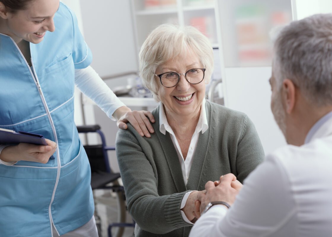 Viatical Settlement: Doctor and senior patient shaking hands in the office