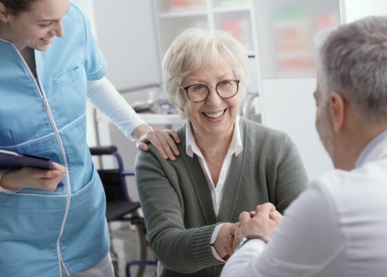 Viatical Settlement: Doctor and senior patient shaking hands in the office