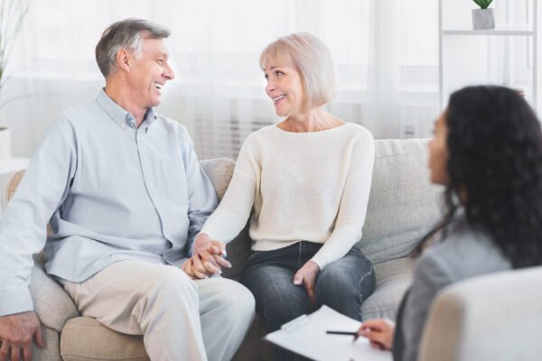 Summit Life Settlements: Happy senior couple with Advisor.