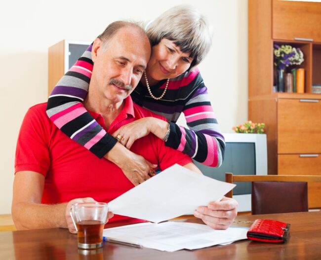 Cash Surrender Value: Happy senior couple embrace while considering their life settlement options. Cash Surrender Value: Happy senior couple embrace while considering their life settlement options.