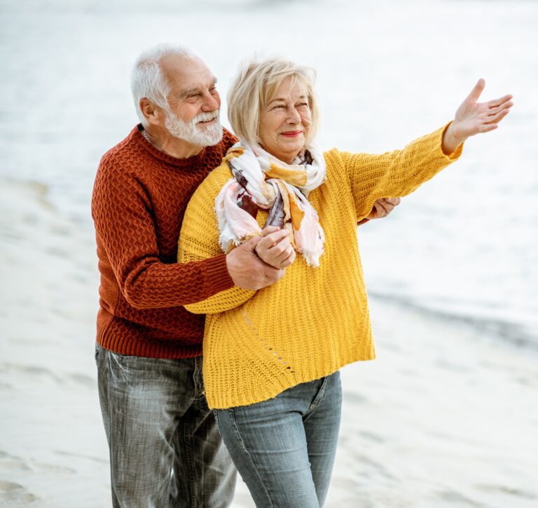 selling term life insurance - happy senior couple on the beach