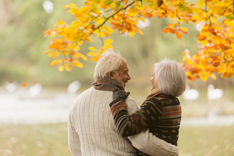 Selling a Life Insurance policy for cash: Happy affectionate senior couple hugging in autumn park