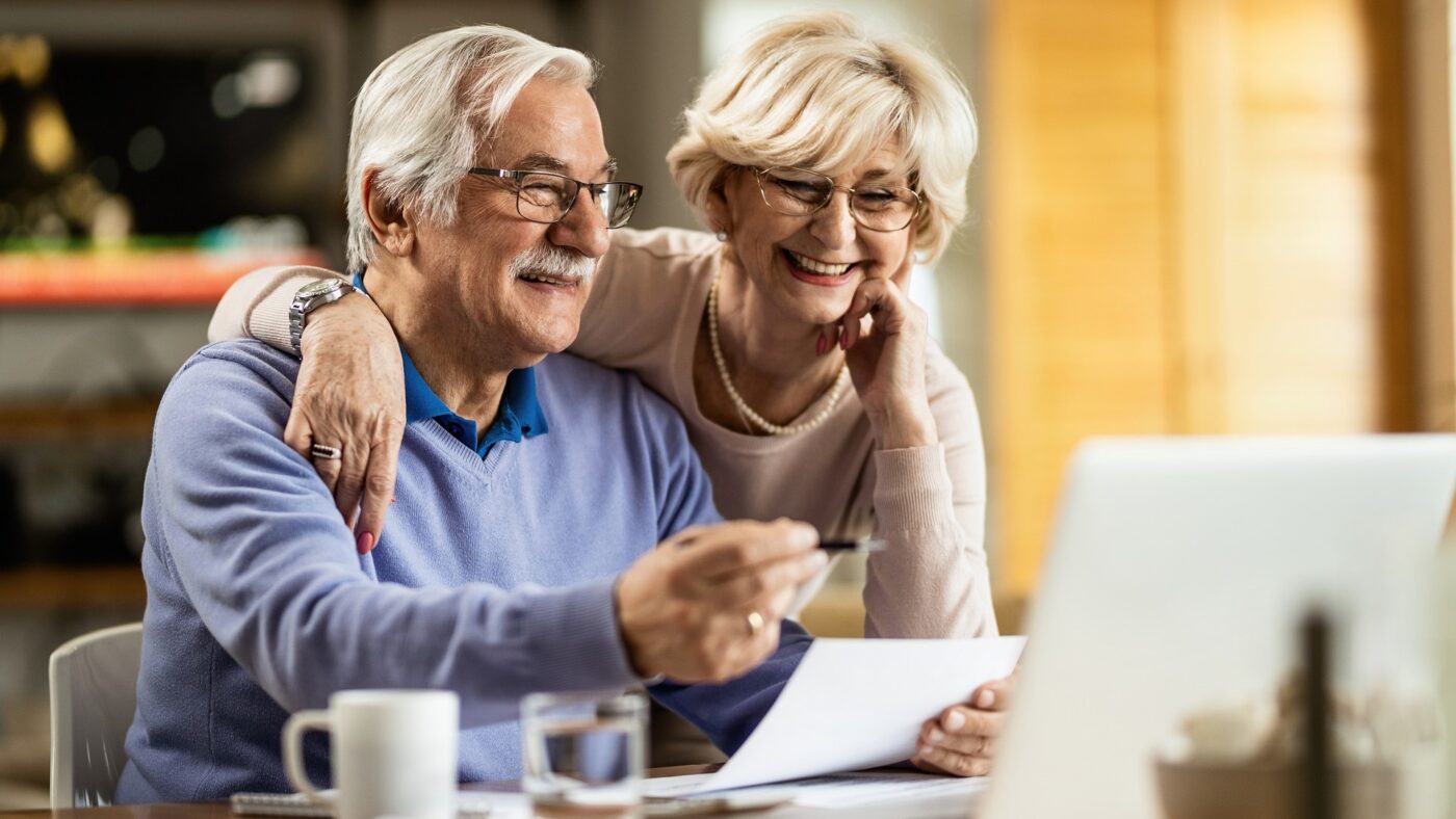 viatical settlement- happy senior couple reviewing their settlement contract