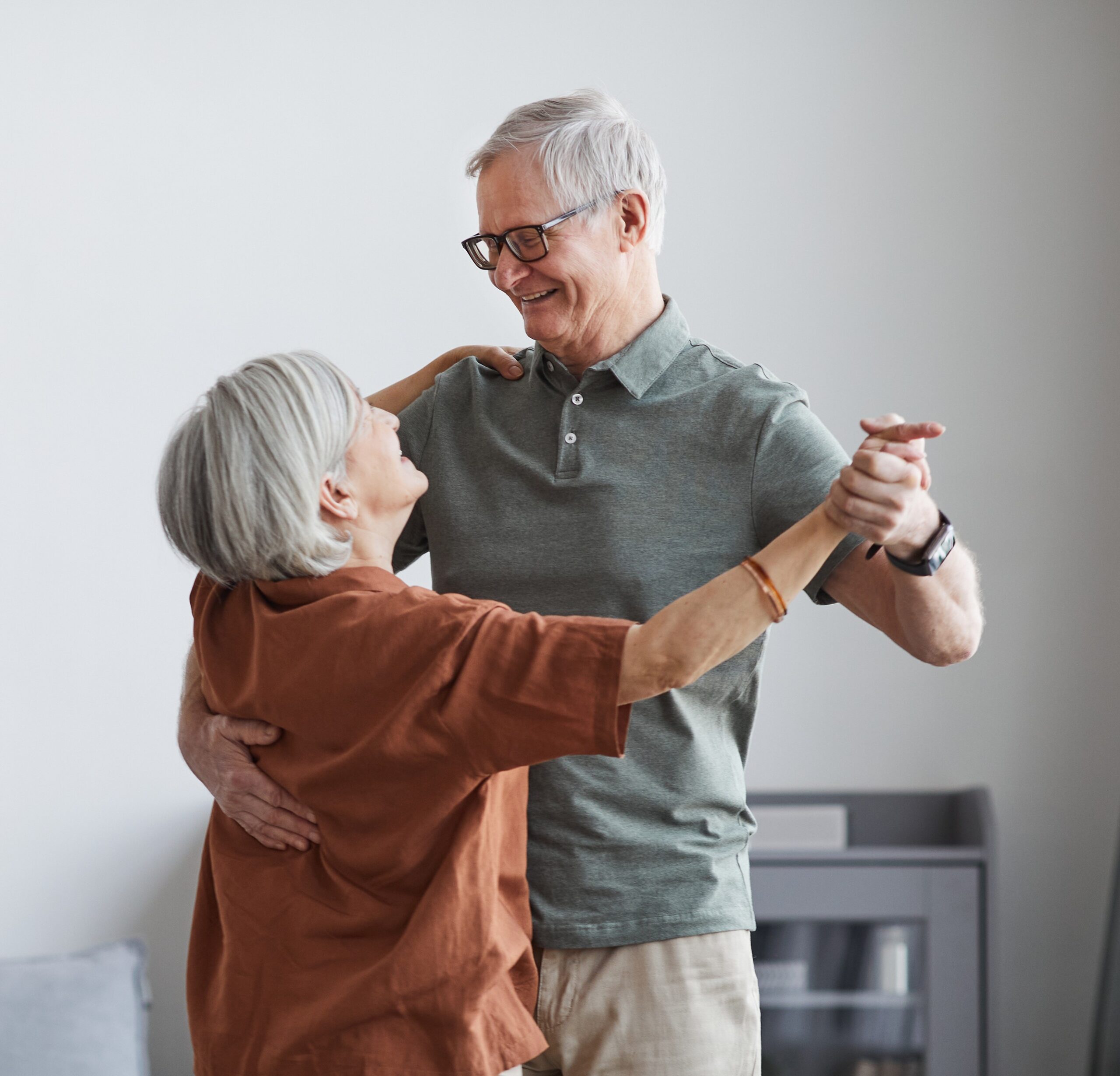 Can I sell my life insurance policy?: Minimal portrait of loving senior couple dancing at home together, copy space